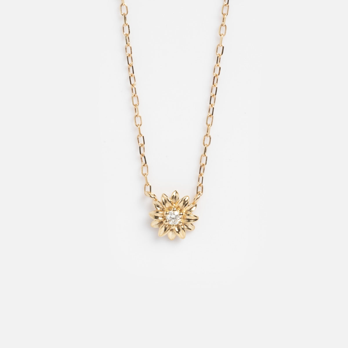 Solid Gold Birth Flower Bloom Necklace with a delicate chain and a flower-shaped pendant, shown on a plain white background.