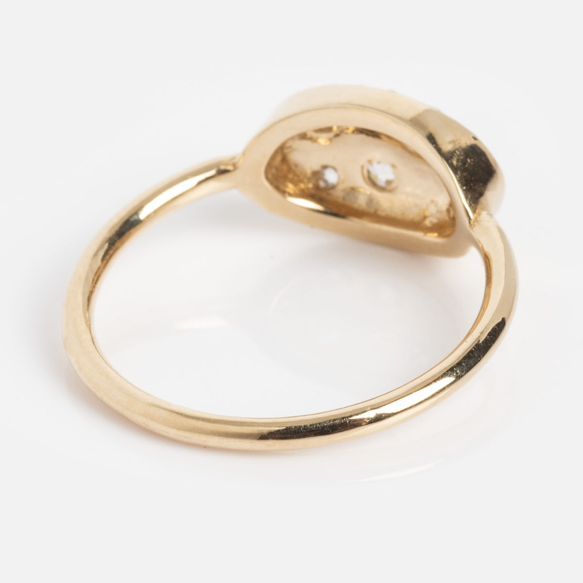 The "Eternal Flame" Soul Ring features a sleek gold band and a raised oval setting; from the back, its hollow underside and two small holes in the setting are visible.