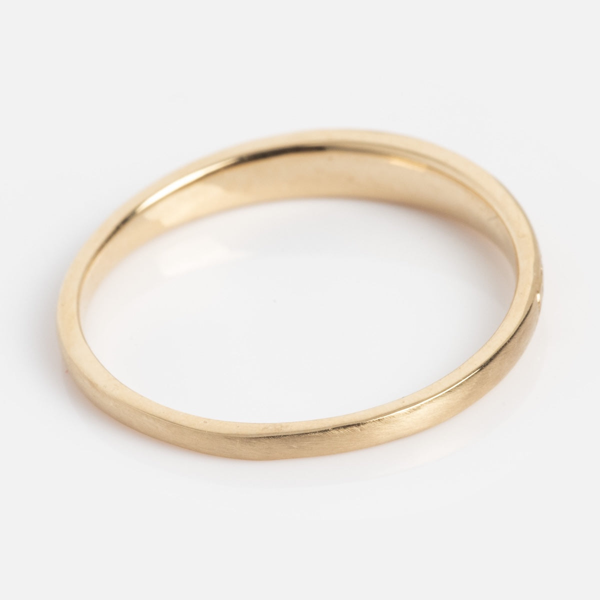 The True Love Never Dies Band is a simple, smooth gold wedding band with a polished finish, shown on a white background.