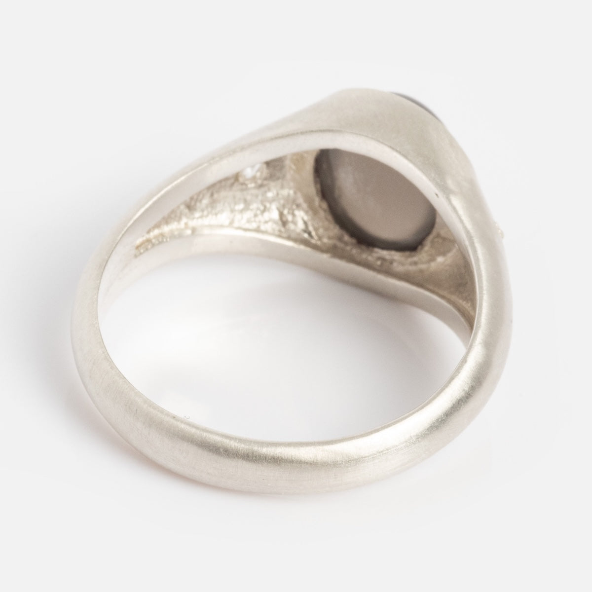 The Vailance Ring is shown from the underside, featuring a smooth, rounded silver band and the back of its oval bezel setting against a plain white background.