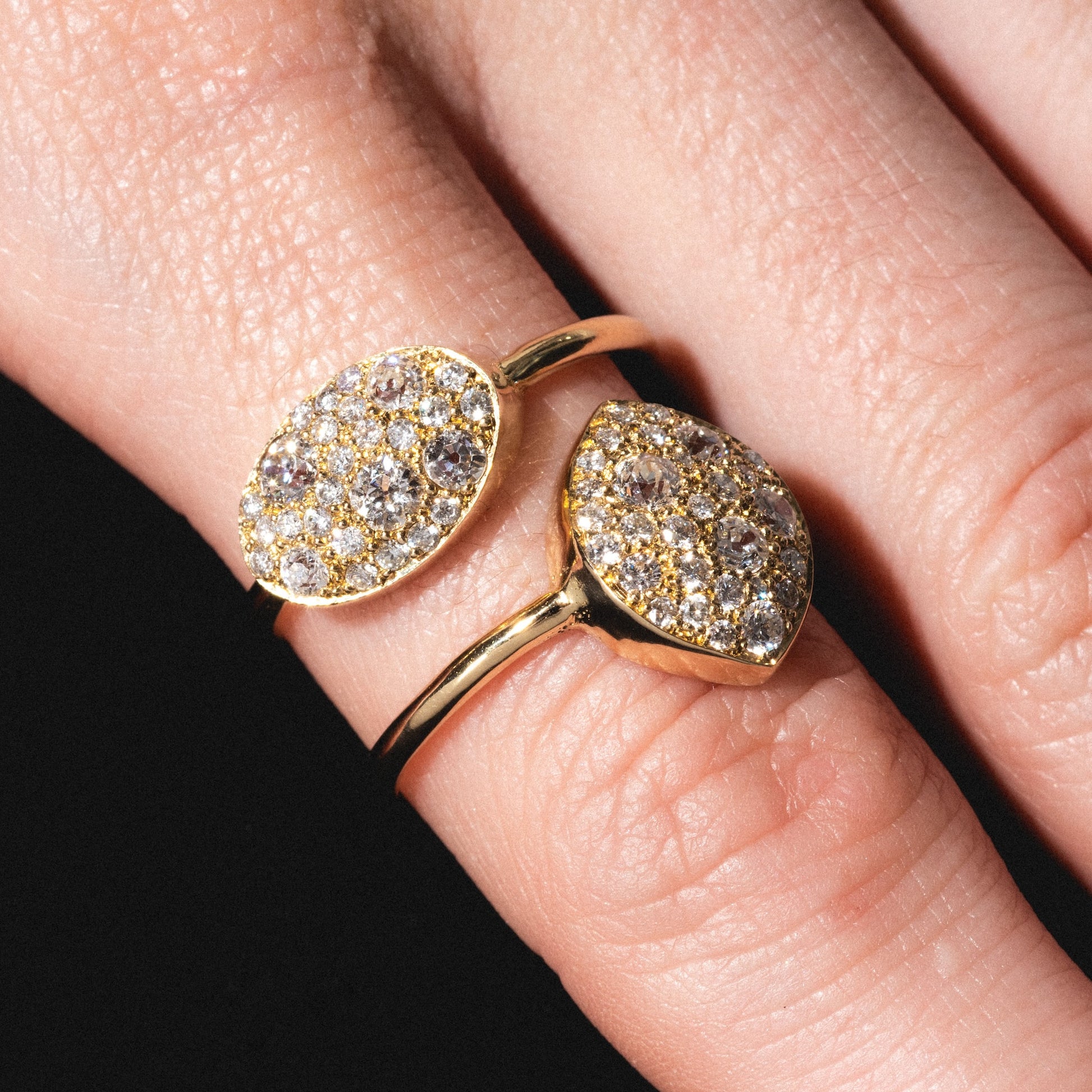 A close-up shows two fingers wearing "My Beloved" Soul Rings, each gold with an oval cluster of sparkling diamonds, set against a black background.
