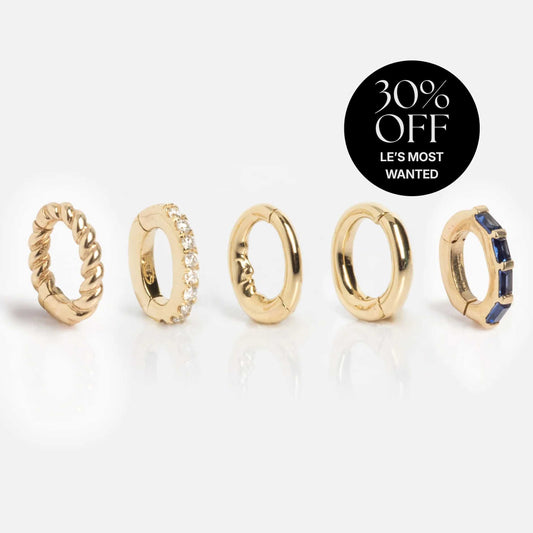 Five Solid Gold Ring Clips with designs like twisted, gemstone-studded, and plain are displayed on a white background. “30% OFF LE’S MOST WANTED” appears in the top right corner—ideal for stacking or pairing with customizable jewelry.