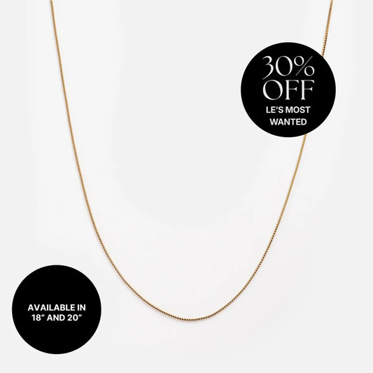 A Solid Gold Box Chain necklace shown on a white background with black circles stating 30% off Les Most Wanted, available in 18" and 20" lengths.