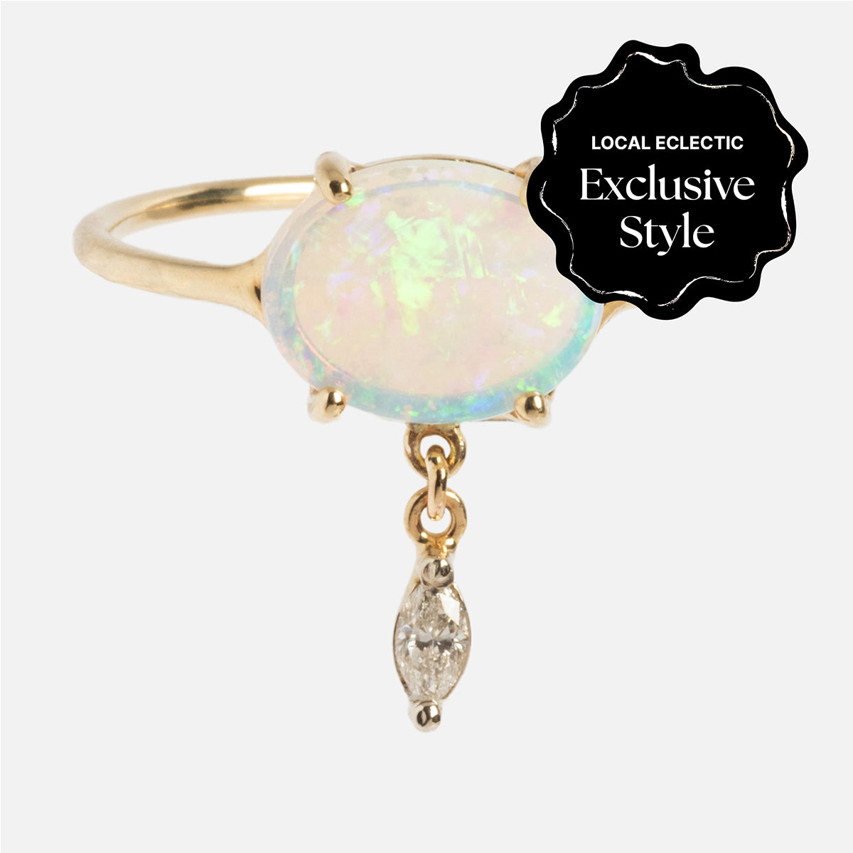 The One of a Kind 14k Opal with Diamond Dangle Ring features a gold band with an oval opal center and a marquise-cut diamond dangle. A black label indicates this is a Local Eclectic Exclusive Style.