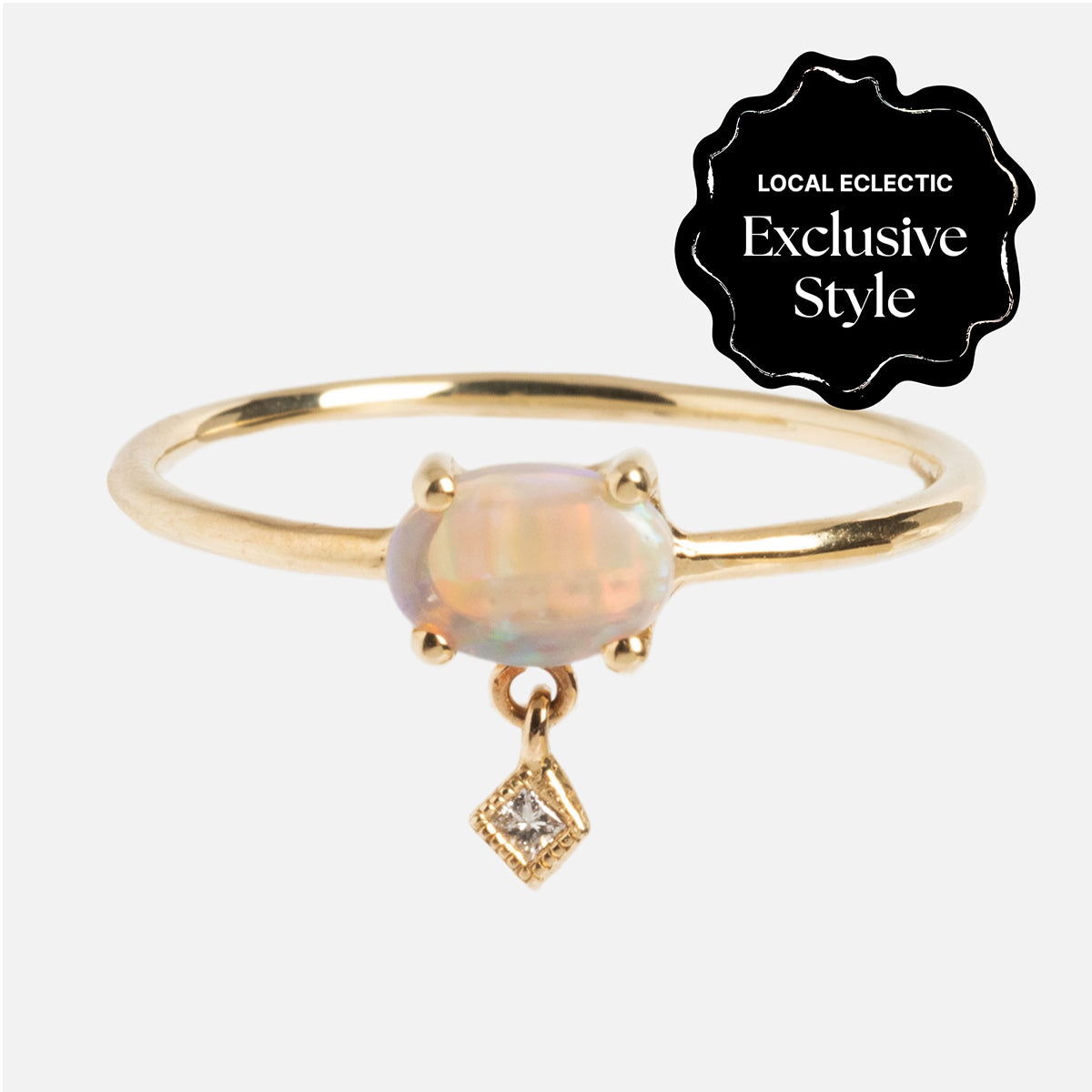 The One of a Kind 14k Sweetest Opal with Diamond Dangle Ring features an oval opal center stone with a diamond-shaped charm, set against a white background and marked as a Local Eclectic Exclusive Style.
