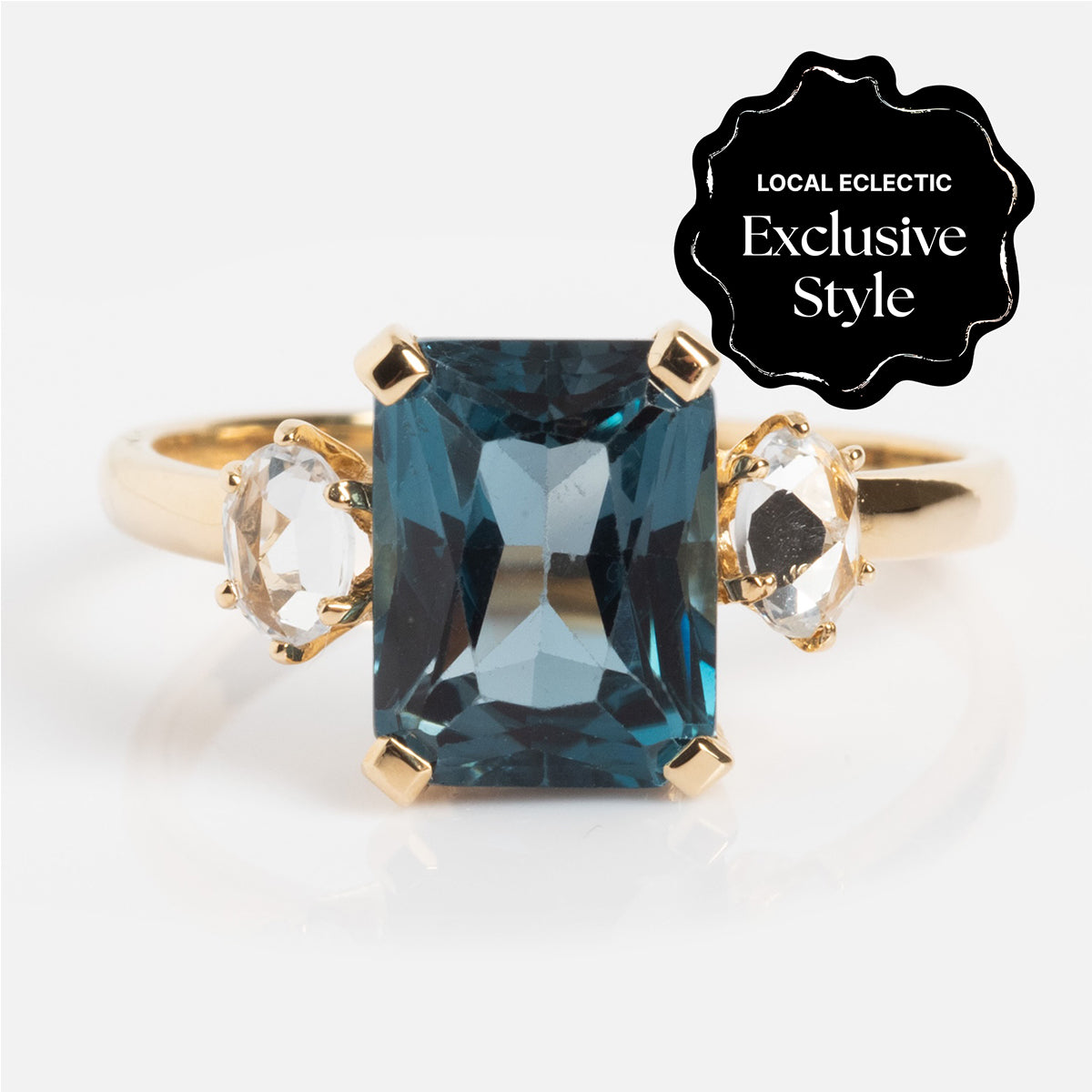 The One of a Kind 14k Vintage Inspired London Blue Topaz and White Sapphire Ring features a large rectangular blue topaz center stone, two smaller white sapphires, and a Local Eclectic Exclusive Style badge in the top right corner.