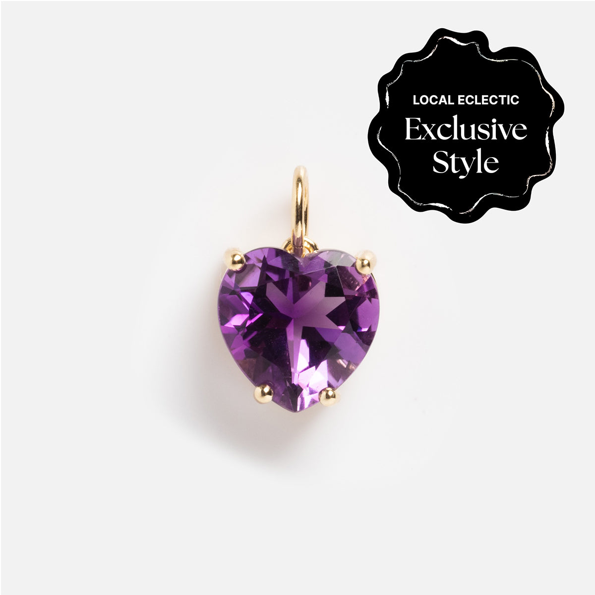 The One of a Kind 14k Amethyst Heart Charm features a heart-shaped purple amethyst with a gold loop on a white background. A black badge displays “Local Eclectic Exclusive Style” in white text.