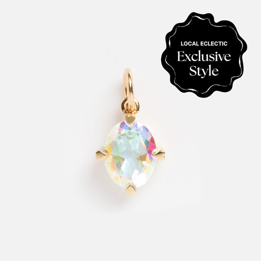The One of a Kind 14k Heart Prong Angel Aura Charm, a gold pendant with an oval iridescent gemstone in heart-shaped prongs, is displayed on a white background. A black label reads, Local Eclectic Exclusive Style.