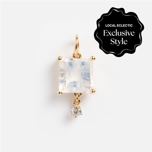 The One of a Kind 14k Princess Cut Rainbow Moonstone with Diamond Dangle Charm features a square-cut moonstone set in gold with a small round diamond dangle. A black LOCAL ECLECTIC Exclusive Style badge appears in the corner on a white background.