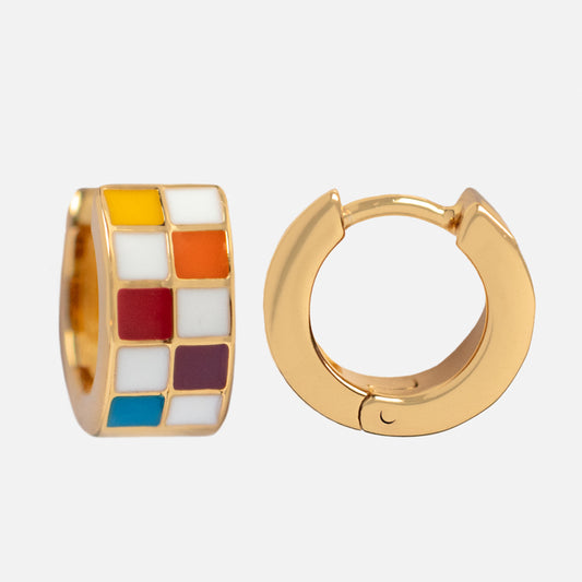 The Checkered Huggie Earrings set features two chunky gold hoops: one plain and one with colorful checkered enamel in yellow, white, orange, red, purple, and blue. Both are displayed on a white background.