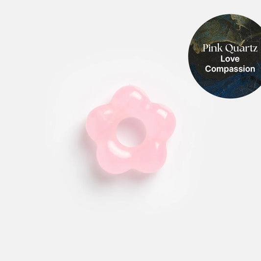A pink quartz flower-shaped Gemstone Spacer Charm from Mod and Jo, perfect for customizable drop earrings, is shown on a white background. Text in the upper right reads: Pink Quartz. Love. Compassion.