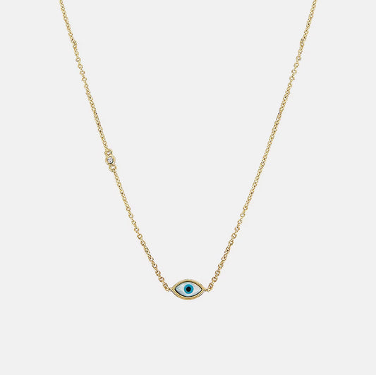 The Madison Evil Eye Necklace features a gold vermeil chain with a blue eye pendant at the center and a small round cubic zirconia along the chain, displayed on a white background.