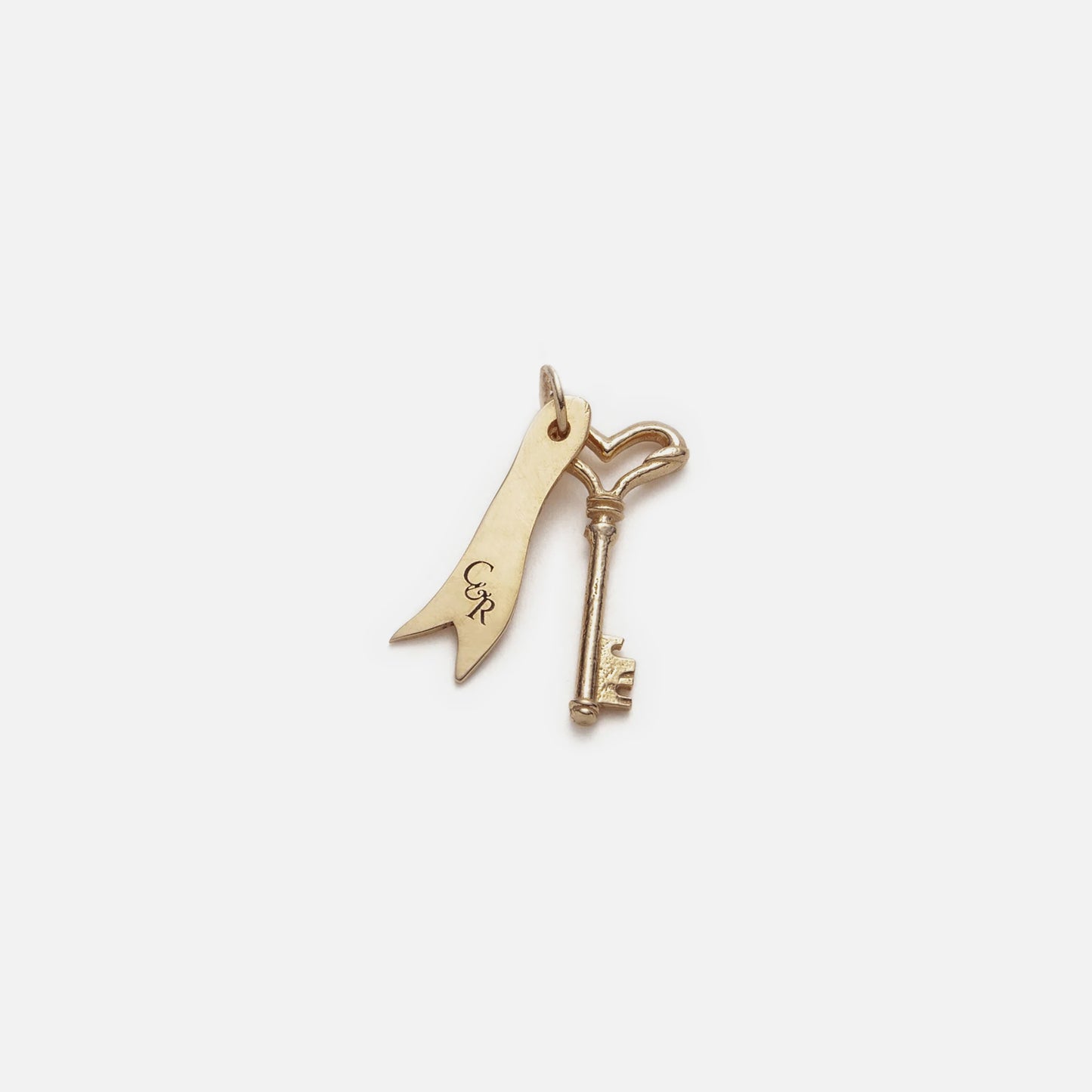 The Customizable You and I Necklace features a 14k yellow gold key and ribbon-shaped charm with CR initials on a small loop, offering elegant personalized initial jewelry displayed on a white background.