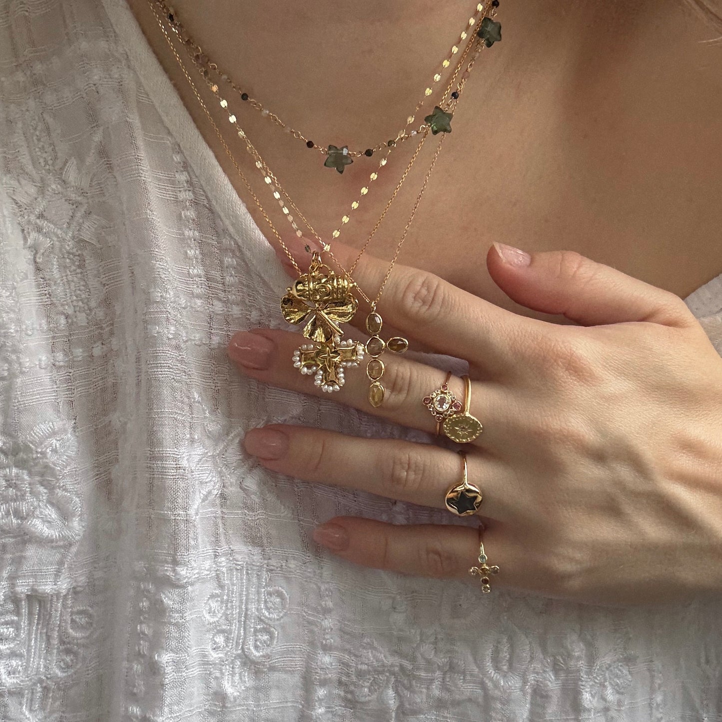Tum and four leaf clover charm worn in a necklace stack