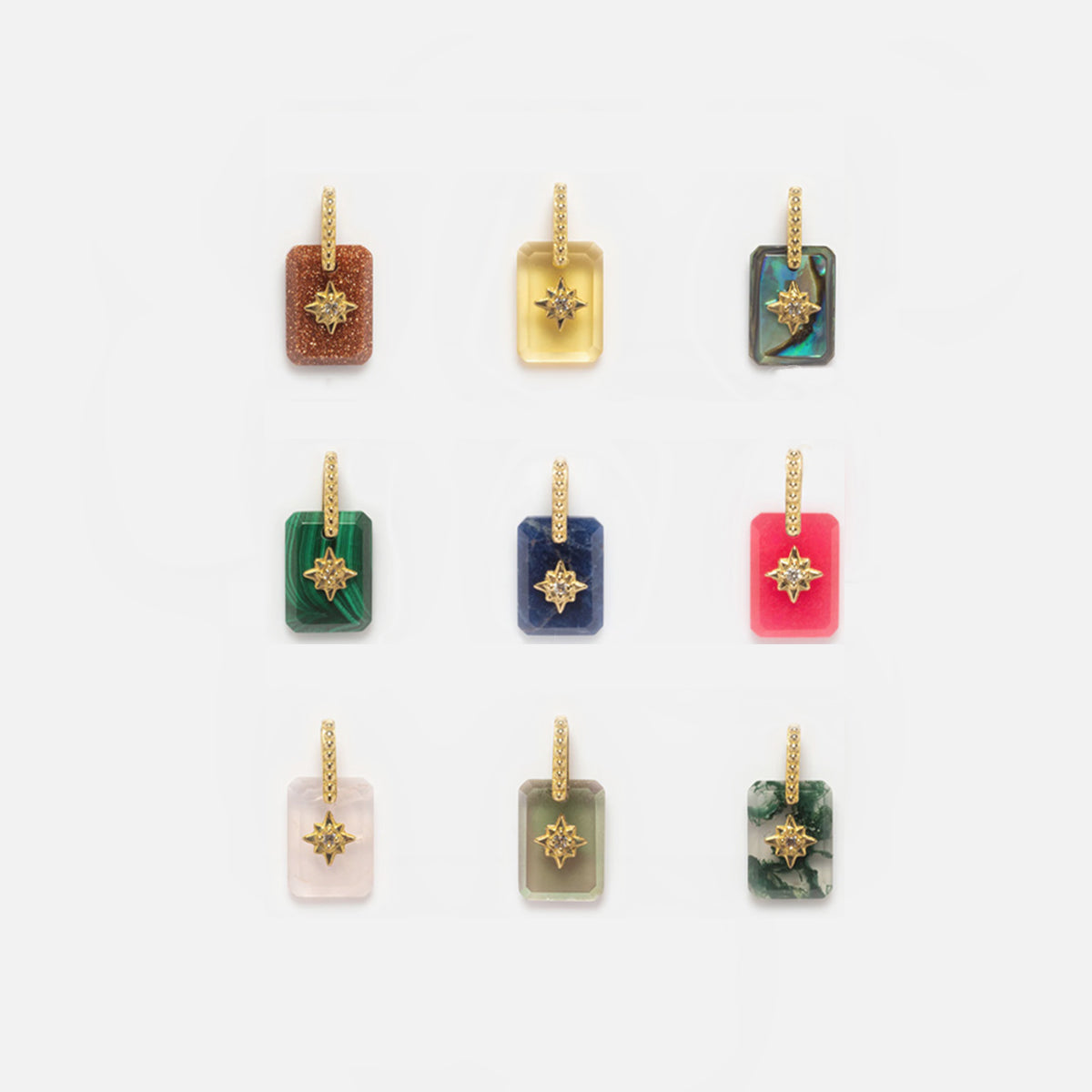 Nine Solid Gold Crystal Amulet Charms for Manifestation, each featuring a unique natural gemstone and gold star accent, are arranged in a 3x3 grid on a white background. Each charm displays a distinct crystal for manifestation.