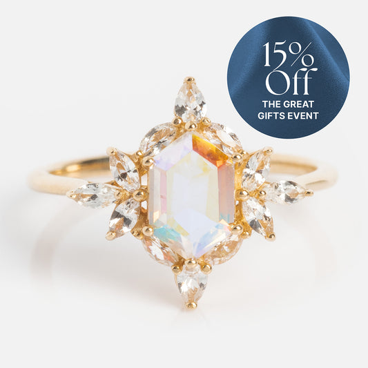 The 14k Angel Aura Quartz Splendor Statement Ring features a large iridescent central gemstone, marquise-cut clear stones, and a blue sticker in the top right corner that reads "15% Off THE GREAT GIFTS EVENT.