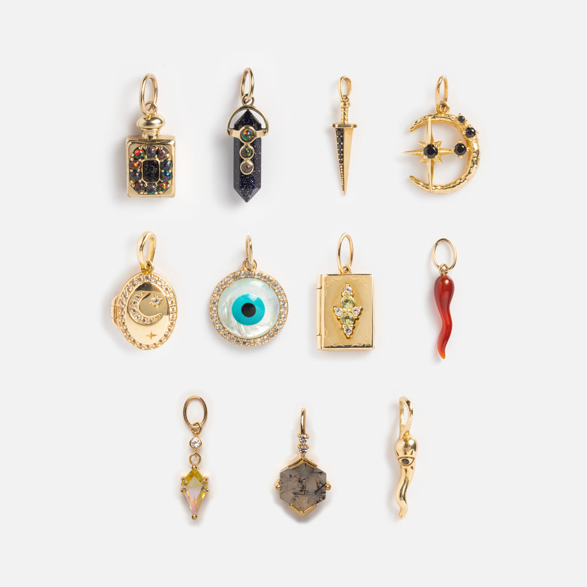 The Solid Gold Amulet Charm collection features eleven unique designs—potion bottle, crystal point, dagger, crescent moon, and more—exclusively from Local Eclectic for crafting your own gemstone necklace masterpiece.