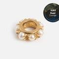 The Solid Gold Anniversaire Charm features a ring shape edged with white pearls and a YEAR 3 Pearl Courage label in the top right, set against a dark marbled blue background.
