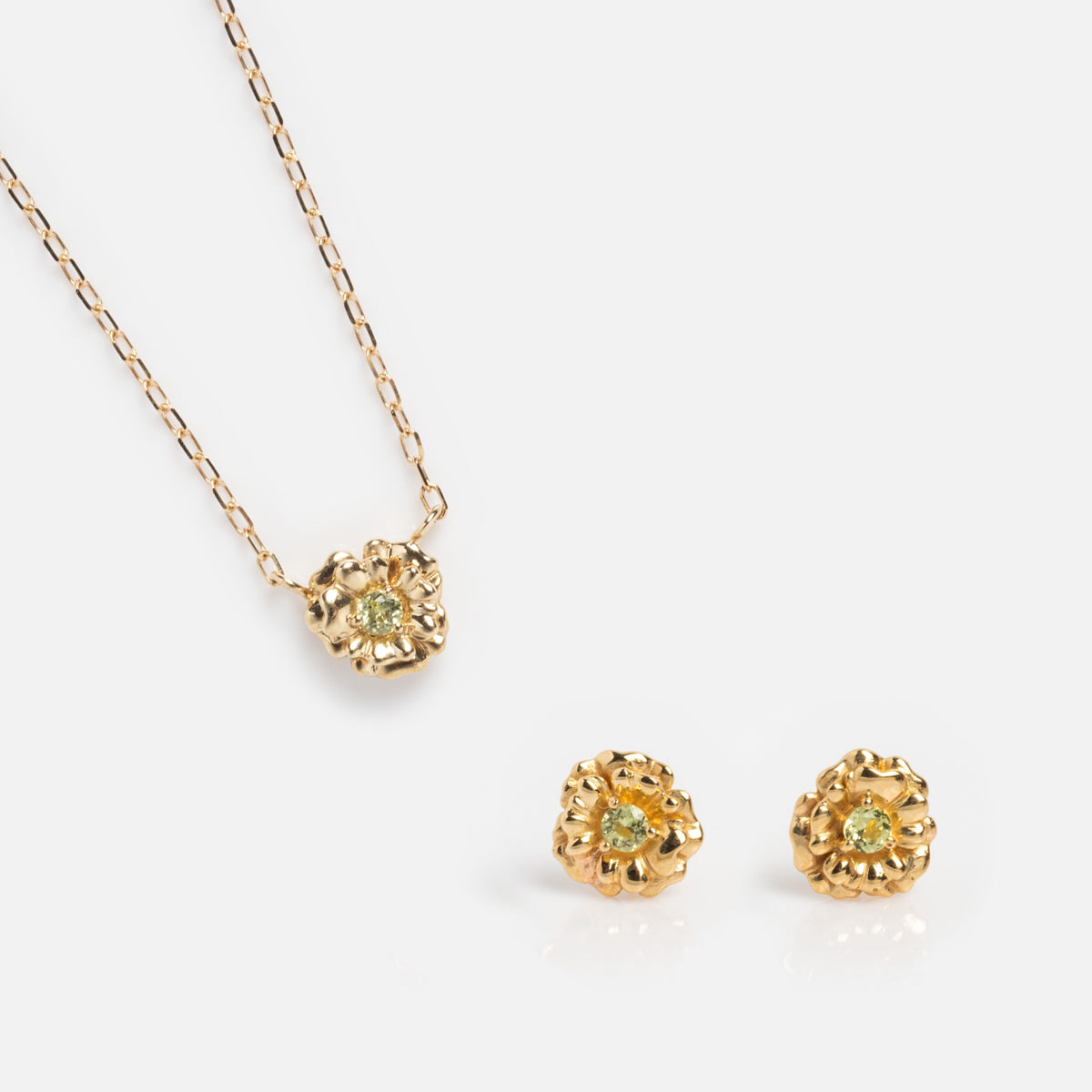 The Solid Gold Birth Flower Gift Set includes a gold necklace and matching stud earrings, each with a textured floral design and yellow gemstone center—an ideal birth flower jewelry gift, shown on a white background.