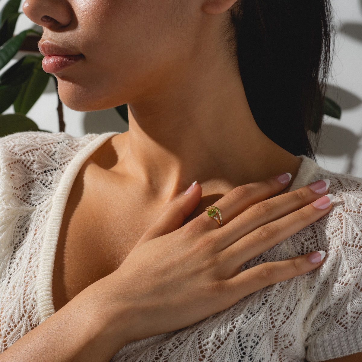 Peridot statement and stacking ring worn by woman