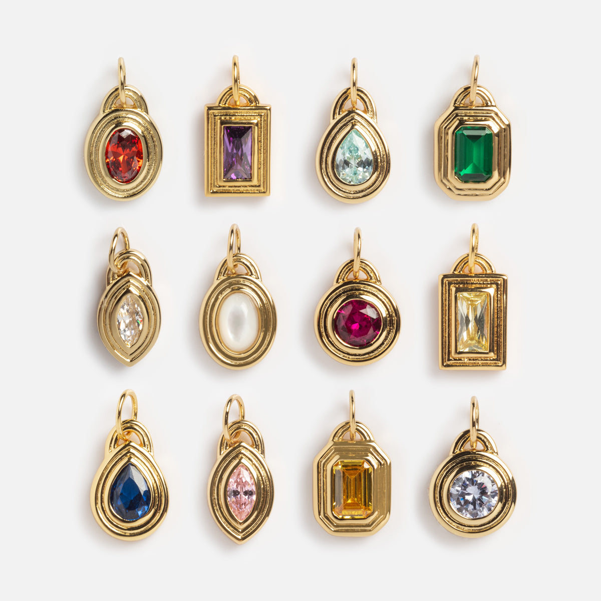 The Monroe Birthstone Charm is a yellow gold plated pendant featuring a unique shape and a colorful central gemstone or pearl—perfect as personalized jewelry or as a birthstone charm.
