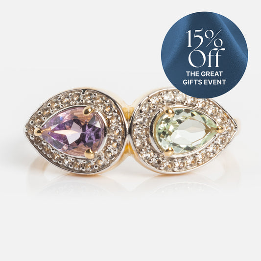 The 14k Pastel Amethyst Toi et Moi Ring features pear-shaped purple and light green gemstones with diamond accents. A blue “15% Off THE GREAT GIFTS EVENT” circle appears in the corner. Perfect heirloom jewelry.