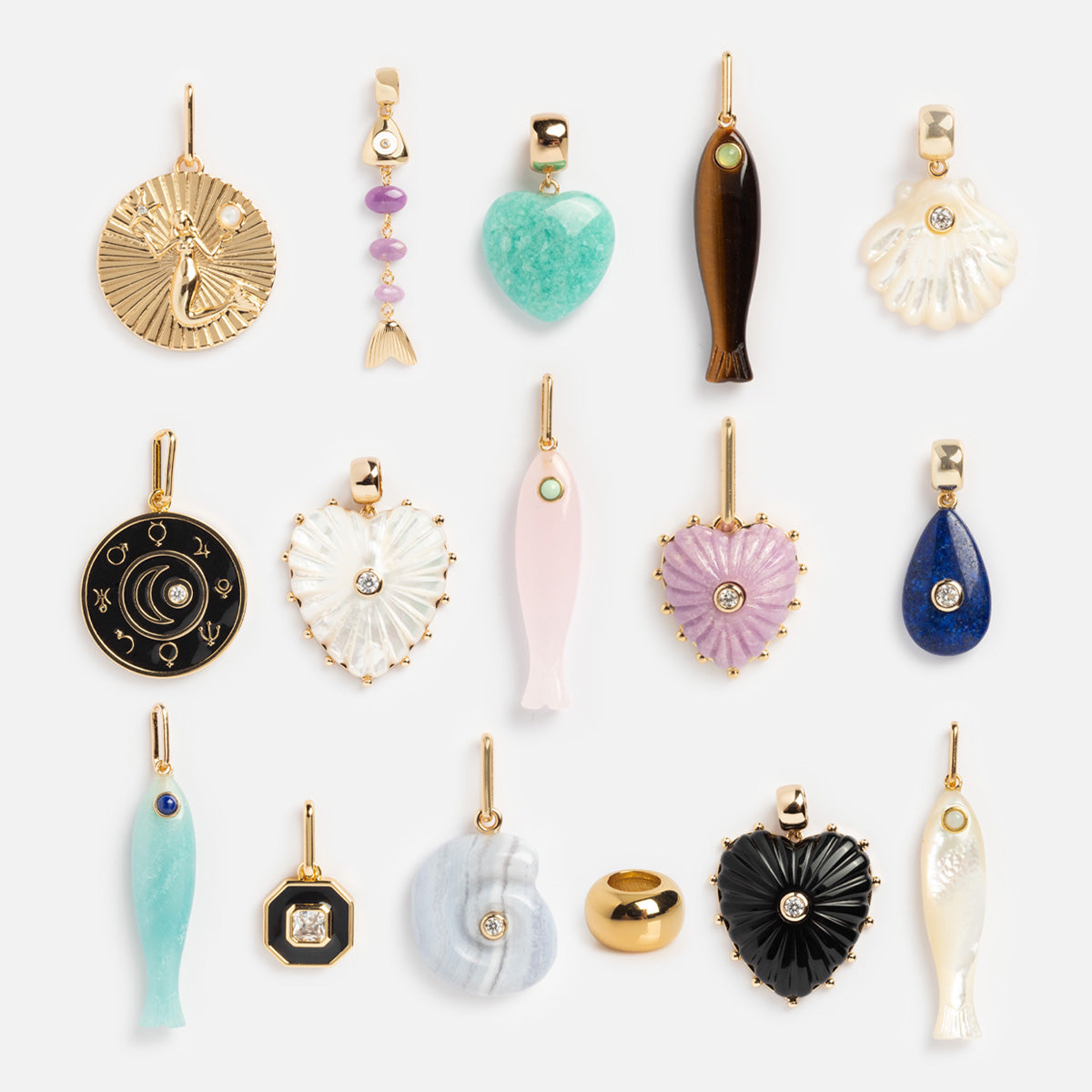 Charms by Thatch: fifteen assorted gold and colorful personalized necklace charms—hearts, fish, shells, circles, and celestial symbols—arranged in three rows on a white background.