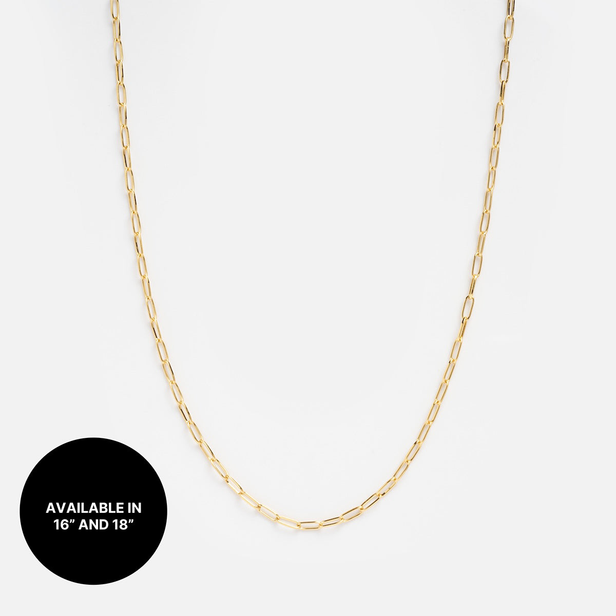A delicate gold plated Chain For Charms necklace is displayed on a white background. A black circle in the lower left corner reads AVAILABLE IN 16 AND 18 in white text—ideal for your next necklace stack.