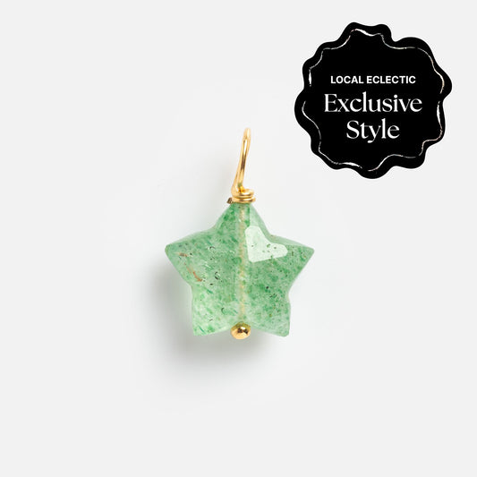 A green star-shaped carved crystal charm pendant with a gold loop, from Devi Arts Collective x Local Eclectic Carved Crystal Charms, displayed on white. A black corner label reads Local Eclectic Exclusive Style—semi precious stone jewelry.