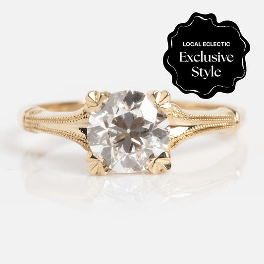 The 14k Elara Ring is a gold ring with intricate detailing, featuring a 1.05 ctw round diamond center and a sleek 1.4 mm band. A black badge in the top right corner reads "Local Eclectic Exclusive Style" in white text.