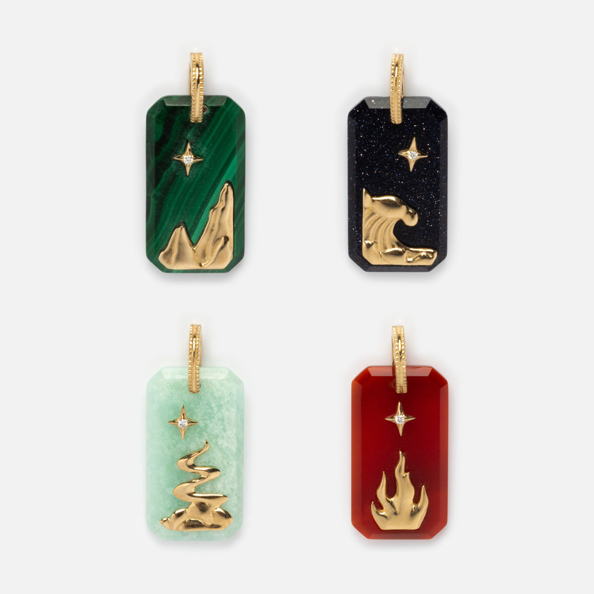 A set of tags featuring elegant designs, including the Solid Gold Crystal Element Charm with gold accents and refined detailing.
