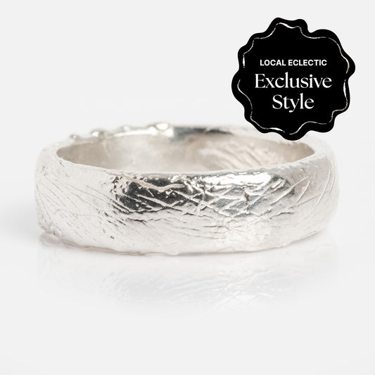 The Everlasting Band is a textured silver ring with a rustic, handcrafted look and 5.6 mm band width, shown on a white background. A black badge in the corner states LOCAL ECLECTIC Exclusive Style.