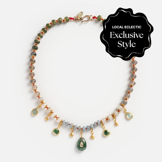 The Winter Garden Necklace, featuring colorful beads, gold star charms, and green gemstone pendants, is displayed on a white background with a black "Local Eclectic Exclusive Style" label in the corner.