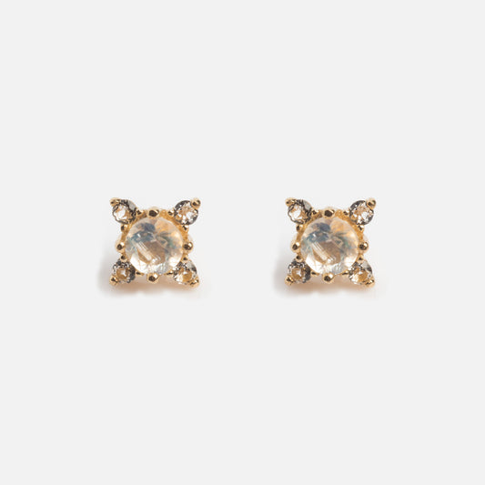 A pair of Solid Gold Moonstone Flat Back Studs featuring a central round moonstone, each accented by four smaller clear stones in a square pattern, displayed on a white background.