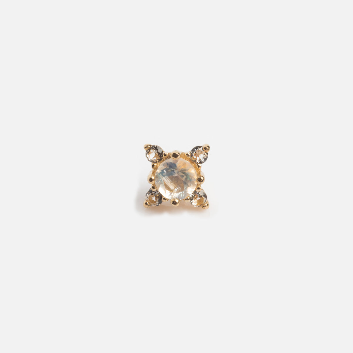 The Solid Gold Moonstone Flat Back Studs are small gold earrings featuring a central round moonstone surrounded by three smaller clear stones arranged in a triangular pattern.