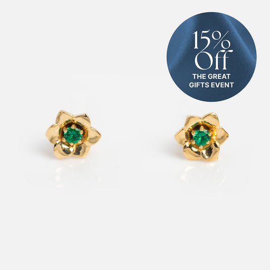 Solid Gold Birth Flower Studs: Solid gold, flower-shaped stud earrings with green gemstone centers. A blue label in the top right shows 15% Off THE GREAT GIFTS EVENT. Perfect birthstone jewelry for any occasion.