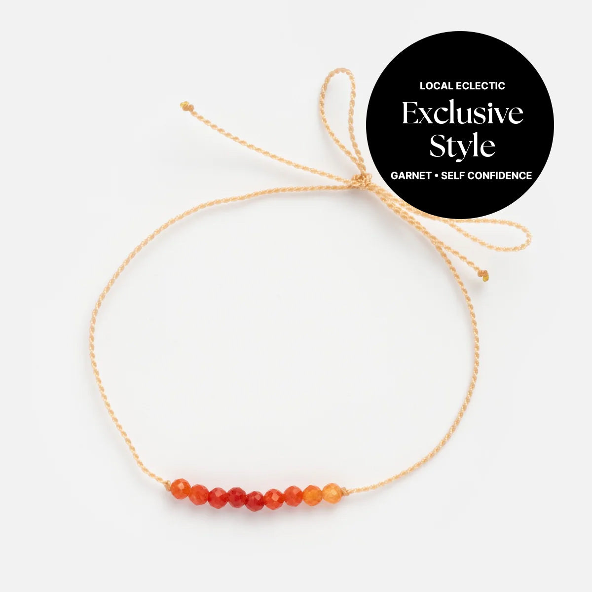 The Anokhi Green x Local Eclectic Gemstone Wish Bracelet features a beige string with seven red and orange garnet beads in a gradient. Made from natural gemstones, it's intention jewelry for self confidence. Black label: Local Eclectic Exclusive Style.