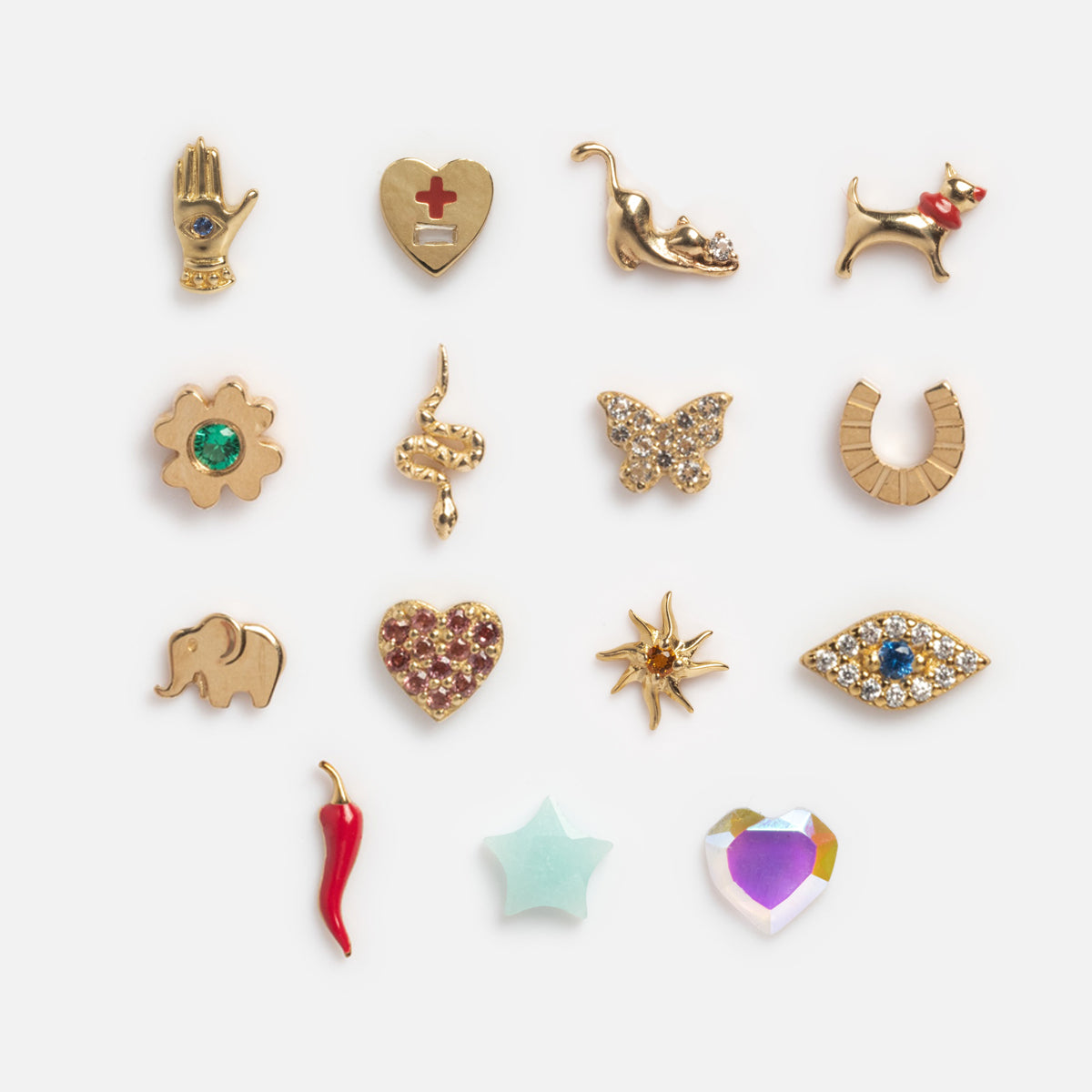 The Solid Gold Tiny Lucky Charm for Glass Charm Locket is a set of 16 small, yellow gold and colorful enamel charms in shapes like hand, heart with cross, cat, flower, snake, butterfly, horseshoe, elephant, sun, and other good luck symbols.