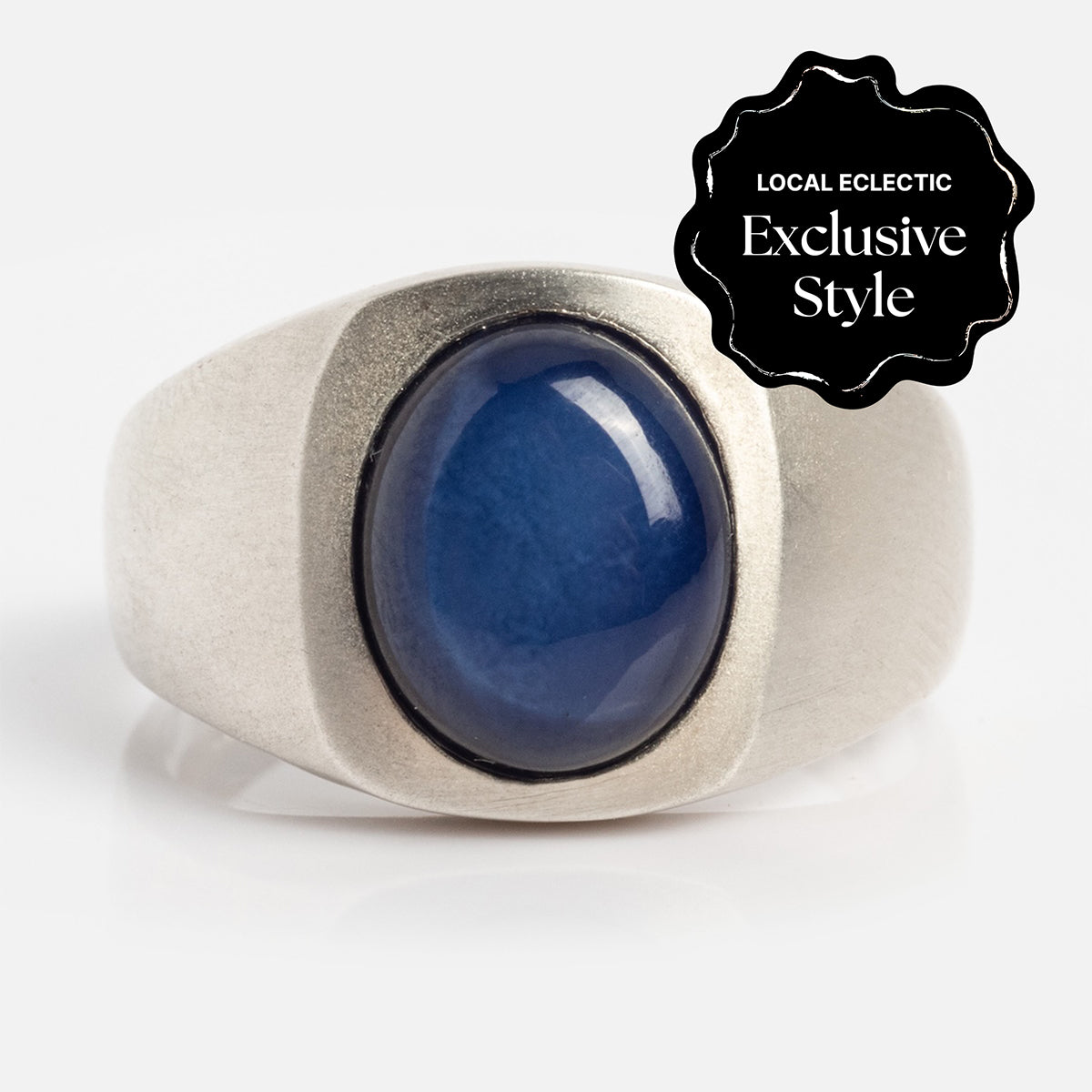 The Guardian Ring features a large, oval-shaped lab created star sapphire (10mm x 8mm) set in silver. A black badge in the top right corner reads "Local Eclectic Exclusive Style.