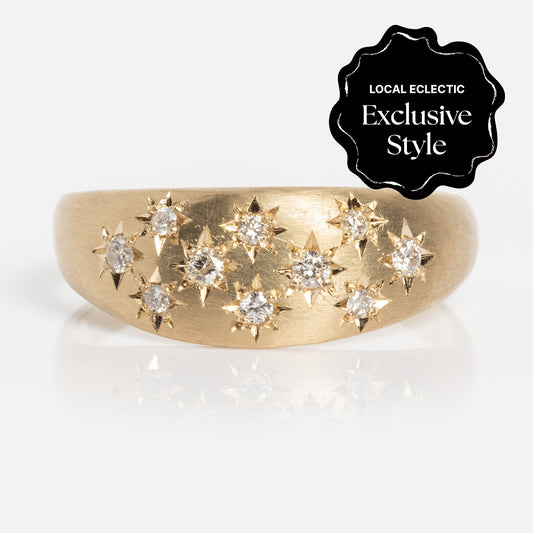 The Half Moon Bombe Ring is a gold band with starburst-set diamonds totaling 0.22 ctw, featuring a black badge in the corner labeled Local Eclectic Exclusive Style.