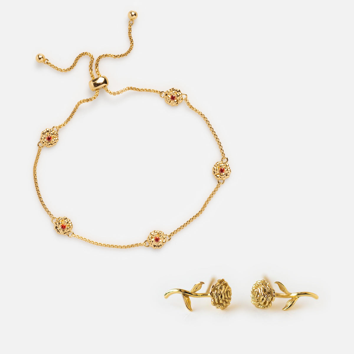 The Birth Flower Gift Set includes a gold birth flower bracelet with rose-shaped charms and matching earrings, both showcasing intricate details, beautifully displayed on a white background.