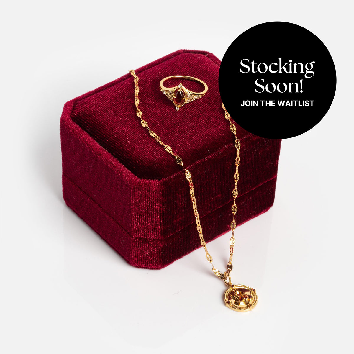 The 2026 January Garnet Capsule Set with Free Gift, featuring vintage-inspired gold ring and necklace, is displayed with a red velvet box. A black circle at the top right says "Stocking Soon! Join the waitlist!" in white text.