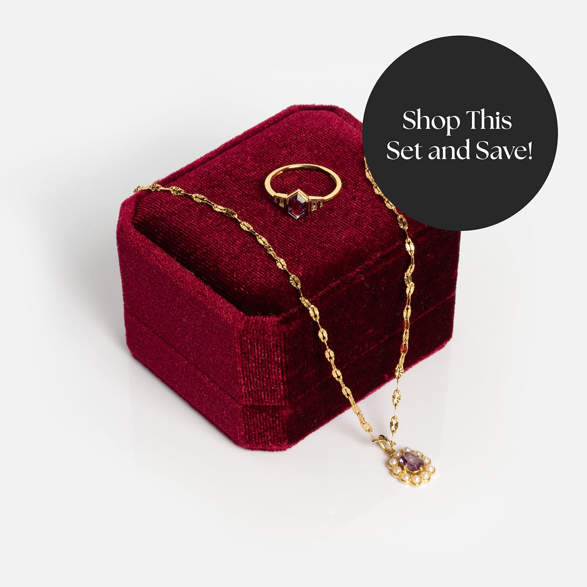 The 2026 June Alexandrite and Pearl Capsule Set with Free Gift, featuring a gold necklace and matching ring with purple gems, is displayed on a red velvet box. A black circle reads, Shop This Set and Save!.