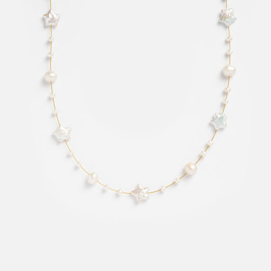 The Suki Necklace features alternating natural and star-shaped pearls on a delicate gold plated chain, displayed against a plain white background.