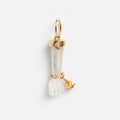 A Local Eclectic exclusive, the Solid Gold Body Language Charm is a pendant shaped like a small hand with a gold cuff and loop at the wrist, featuring a translucent design and adorned with a yellow gemstone.