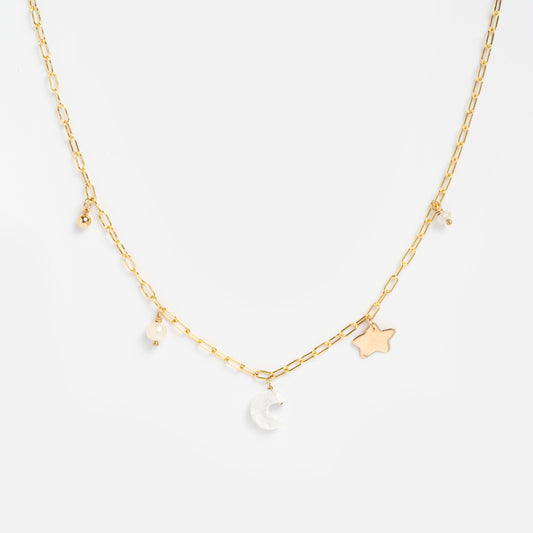 The Celine Charm Necklace Sample features a delicate 14k gold-filled chain with brass charms—a crescent moon, star, plus small pearls and moonstone pearl beads—displayed on a white background.