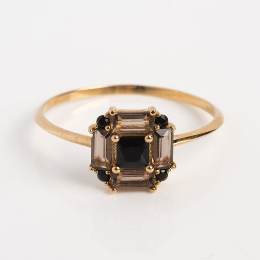 The 14k Vintage Inspired Art Deco Engagement Ring showcases a rectangular cluster of baguette-cut and round black stones in a geometric design on a slim band, crafted from recycled gold and displayed on a white background.