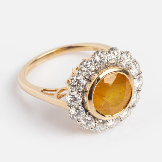 The Solid Gold Yellow Sapphire and Diamond Ring Sample Size 7 showcases a large round yellow sapphire center, encircled by clear sparkling diamonds, all set in 14k solid gold and displayed on a light background.