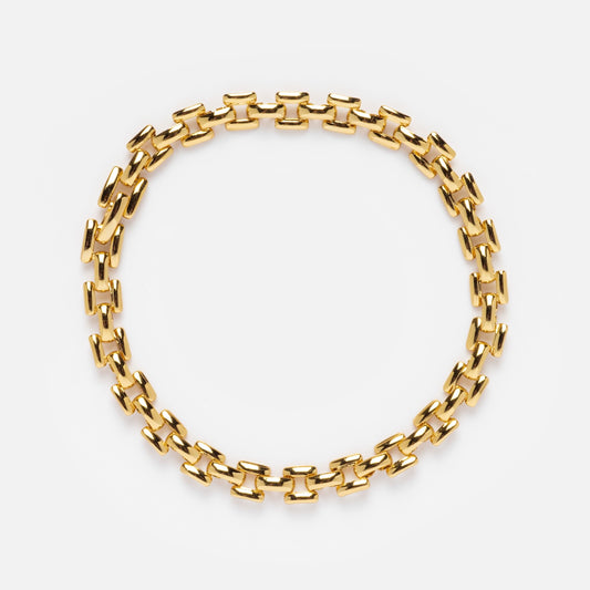 The Watch Band Bracelet features gold rectangular links in an oval shape, displayed on a white background, offering a chic look similar to pieces from Local Eclectic.