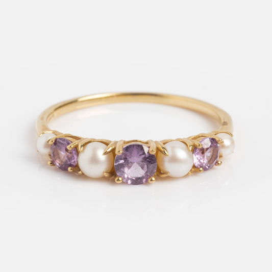 The Solid Gold 2024 June Capsule Classic Alexandrite and Pearl Band Sample features two round lab alexandrites and three white pearls in an alternating yellow gold band, shown on a plain white background.